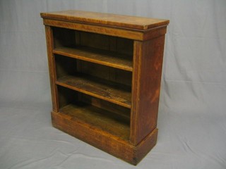 A 19th Century mahogany bookcase, the crossbanded top with satinwood stringing, fitted 2 adjustable shelves, raised on a platform base 31"