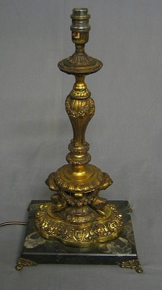 A gilt metal table lamp supported by 2 cherubs with swag decoration, raised on a marble plinth 19"
