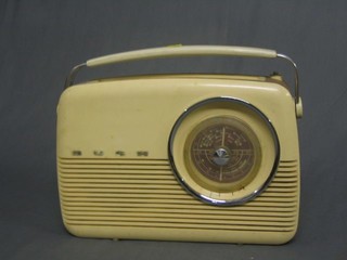 A 1960's Bush portable radio in pink plastic case (back loose and aereal f)