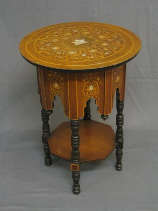 An Edwardian circular inlaid mahogany Moorish style occasional table with shaped apron, octagonal undertier and raised on turned supports 20"