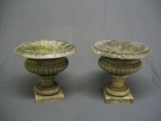 2 circular stone urns of campanular form 15"