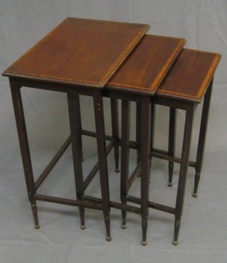 A nest of 3 Edwardian inlaid mahogany interfitting coffee tables, raised on square tapering supports 19"