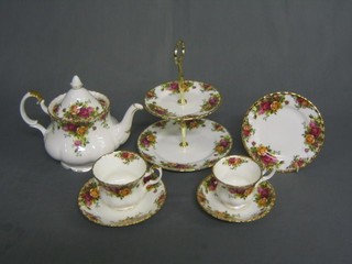 A 26 piece Royal Albert Old Country Rose pattern tea service comprising 2 tier cake stand, twin handled bread plate 12", specimen vase 5", teapot, cream jug and sugar bowl, 2 breakfast cups and 2 saucers, 5 tea cups and 5 saucers (1 cracked), 6 tea plates���������??�