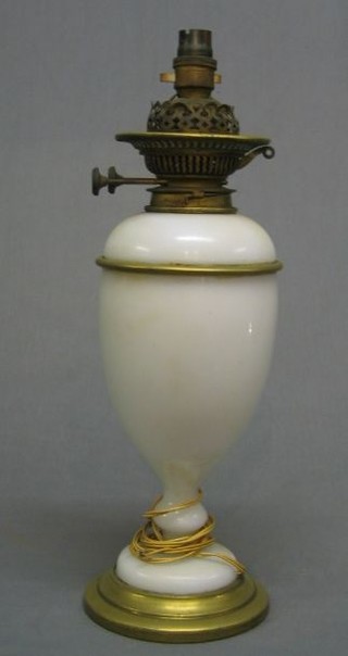 An opaque glass oil lamp with reservoir and gilt metal mounts (crack to the side) converted to electric table lamp