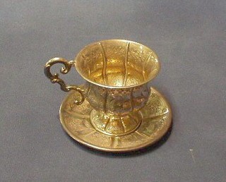 A Continental embossed silver cup and saucer