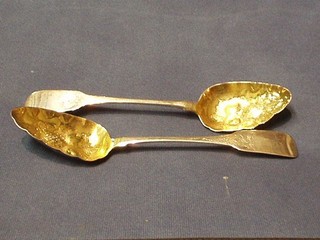 A pair of George III Irish silver fiddle pattern engraved berry spoons, with embossed parcel gilt bowls, Dublin 1814, makers mark RH and also marked N West, 4 ozs