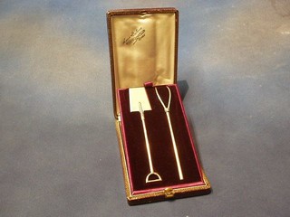 A handsome French silver gilt presentation set in the form of a spade and pitch fork, in fitted leather case