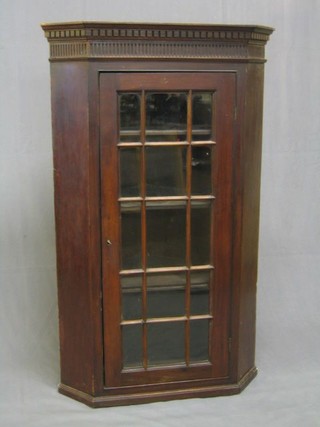 A 19th Century mahogany corner cabinet with moulded and dentil cornice, fitted shelves enclosed by lattice glazed panelled door 29"