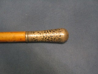 A 19th Century Eastern molacca cane with Eastern engraved silver top