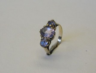 A lady's 9ct gold dress ring set an oval cut amethyst supported by 2 circular cut amethysts