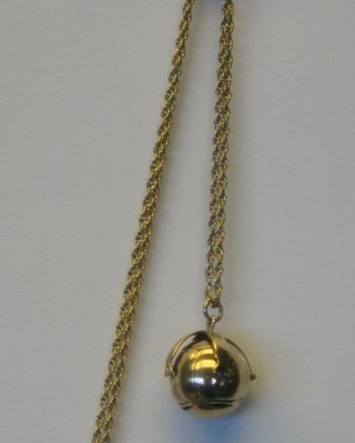 A gilt metal Masonic ball charm hung a gold chain