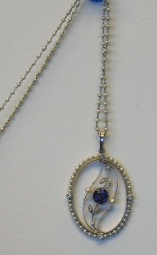 A very attractive Edwardian pierced gold pendant set an amethyst supported by 2 diamonds and surmounted by a pair of leaves set 4 diamonds supported by numerous smaller diamonds and pearls, hung on a chain interspaced pearls