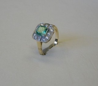 A lady's 18ct gold dress ring set a square cut emerald surrounded by 12 diamonds (approx 0.54/1.06ct)