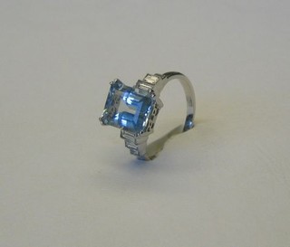 A lady's 18ct white gold dress ring set a rectangular cut aquamarine supported by 6 baguette cut diamonds (approx 0.43/2.95ct)