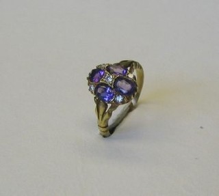 A  19th Century style 18ct gold dress ring set 4 oval cut amethysts supported by 5 diamonds
