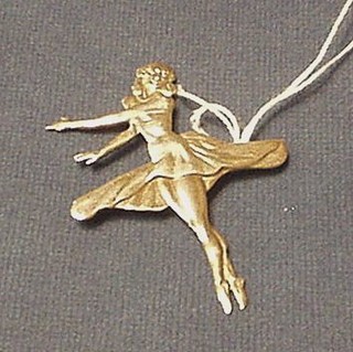 A large silver brooch in the form of a dancer