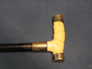A Victorian ebony walking cane with silver and ivory handle (f) 