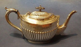 An oval Britannia metal teapot with demi-reeded decoration