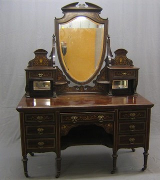 Ensuite with the aforementioned two lots - A Maples & Co Victorian inlaid mahogany dressing table with shield shaped mirror flanked by a pair of glove drawers above a niche, the base fitted 1 long drawer flanked by 6 short drawers, raised on turned supports 54"