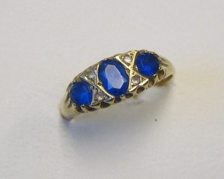 A lady's 9ct gold dress ring set 3 oval cut blue stones