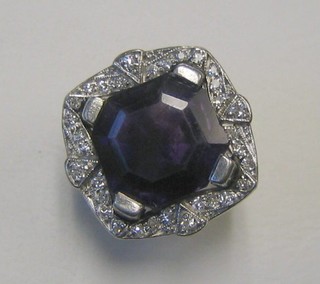 A lady's 18ct white gold dress ring set a large cut amethyst supported by diamonds