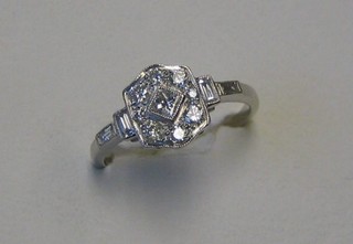 A A lady's Art Deco style white gold dress ring set numerous diamonds with baguettes to the shoulders