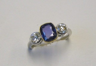 A lady's 18ct white gold dress ring set a rectangular cut sapphire supported by 2 diamonds (approx 1.72/0.60ct)