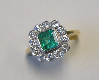 A lady's attractive gold dress ring set a square cut emerald surrounded by 12 diamonds