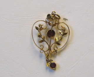 An Edwardian pierced 9ct gold pendant, set orange stone and demi-pearls hung on a gold chain