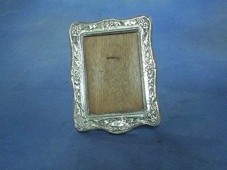 An Edwardian embossed silver easel photograph frame Birmingham 1904, 7"