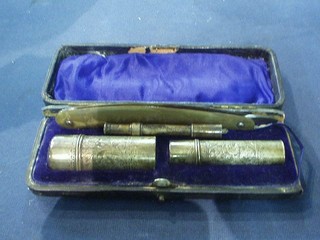 An Edwardian engraved silver shaving set, Birmingham 1909, comprising shaving brush holder, canister, a cut throat razor and a pencil holder?, cased