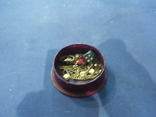 A leather stud box containing a gold plated stock pin, gilt metal chain, 4 dice, red enamelled heart shaped locket etc