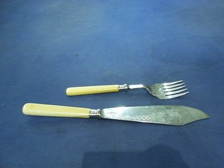 A pair of silver fish servers with engraved blades and ivory handles Sheffield 1913 by Walker & Hall (fork handle cracked)