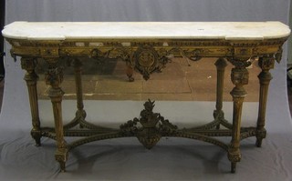 A handsome 19th Century gilt wood and plaster console table with white veined marble top and mirrored back, with armorial decoration to the apron, raised on turned and fluted supports 71"
