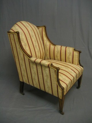 An Edwardian inlaid mahogany armchair upholstered Regency striped material, on square tapering supports