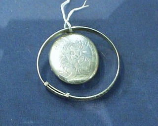 An engraved silver locket and an engraved silver bangle