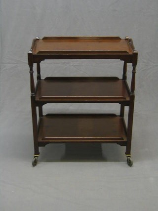 A mahogany 3 tier tea trolley, raised on turned supports 27"