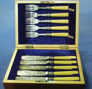 A set of 5 silver plated fish knives and forks contained in a walnut canteen