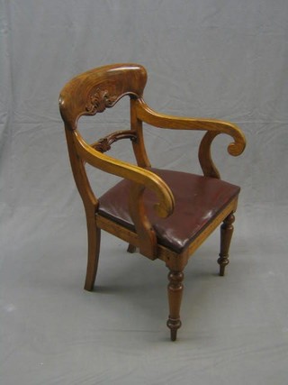 A Continental carved bleached mahogany open arm carver chair with mid rail and upholstered drop in seats on turned supports