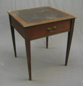 An Edwardian inlaid mahogany games table, the interior inlaid a chessboard with slides to the side, raised on square tapering supports 25"