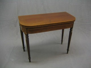 A 19th Century mahogany D shaped card table, inlaid satinwood stringing and raised on ring turned supports 36"