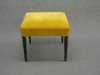 A 19th Century rectangular mahogany stool upholstered in yellow material, on turned supports 20"