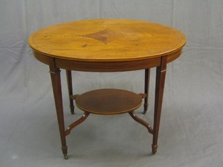 An Edwardian Sheraton style oval inlaid mahogany 2 tier occasional table, raised on square tapering supports ending in spade feet, 36"