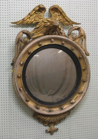 A Regency convex plate wall mirror contained in a gilt ball studded frame surmounted by an eagle 26"