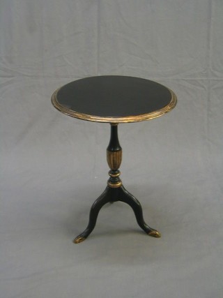 A circular ebonised and gilt painted wine table, raised on  pillar and tripod supports 17"