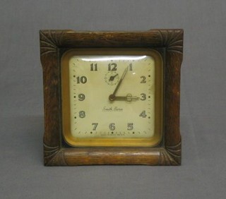 A 1930's Smiths alarm clock contained in an oak case