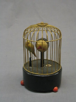 A clock automaton in the form of a caged budgerigar, the dial in the form of a globe, by the Precision Watch Co. London