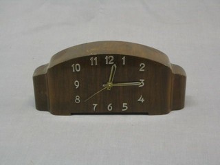 An Art Deco electric mantel clock contained in an arched walnut case with Arabic numerals