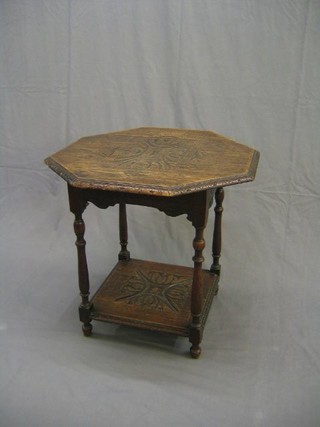 A Victorian octagonal carved oak 2 tier occasional table raised on turned and block supports 30"