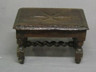 A small carved oak stool on turned and block supports with spiral turned H framed stretcher 12"